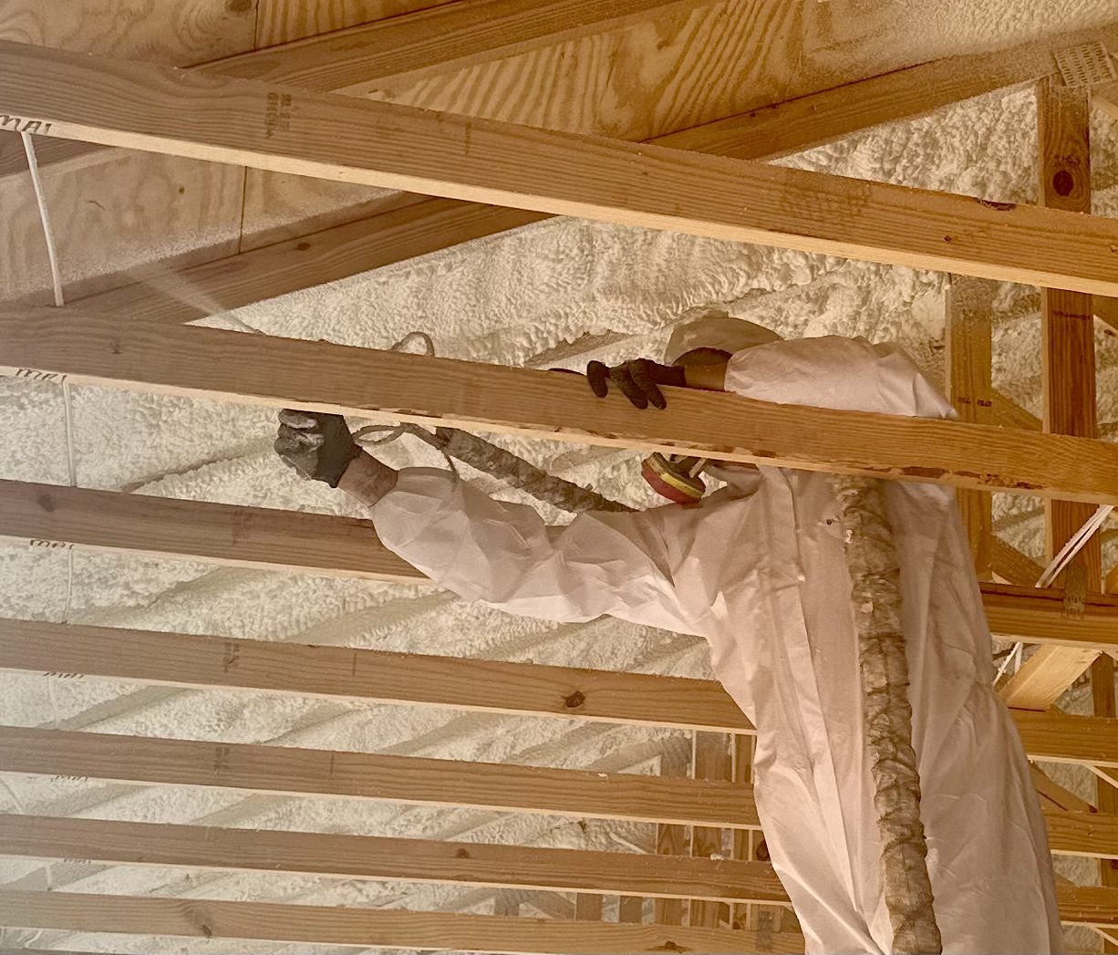 Insulflo crew installing spray foam at the roofline in a Riverview, Florida attic.