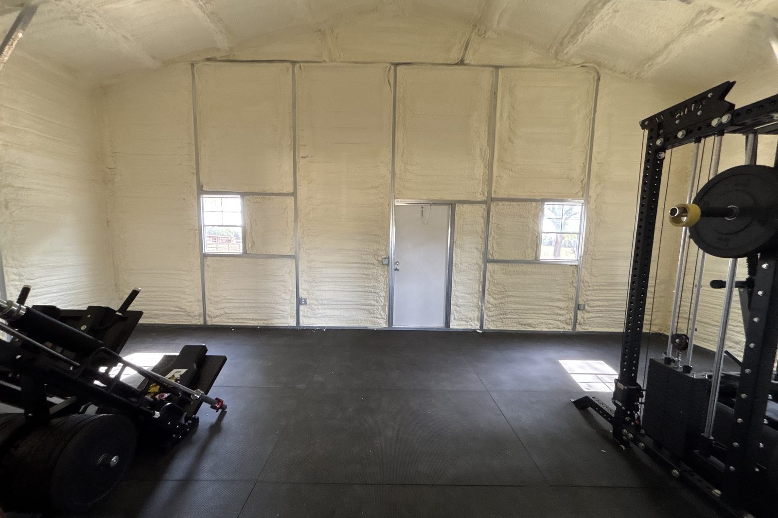 Open-cell spray foam covering attic rafters at the roofline